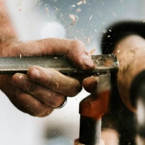 person holding silver and orange pipe