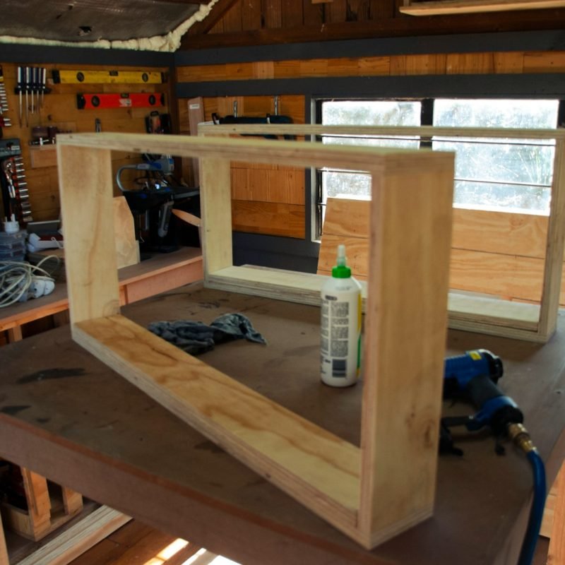 a wooden frame with a bottle of glue on top of it